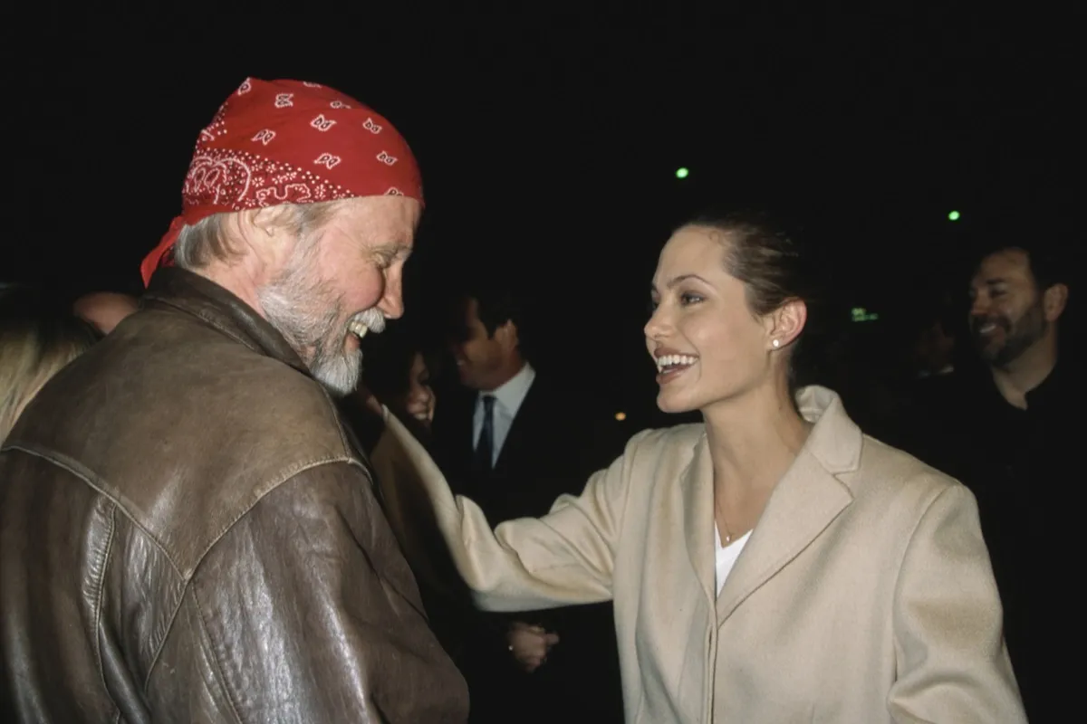 Angelina Jolie and Jon Vought talking to each other at the 1998 premiere of "Playing by Heart" in Los Angeles, California.