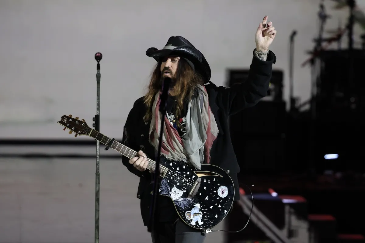 Billy Ray Cyrus with long hair and wearing a black cowboy had, performs at Donald Trump's Liberty Ball