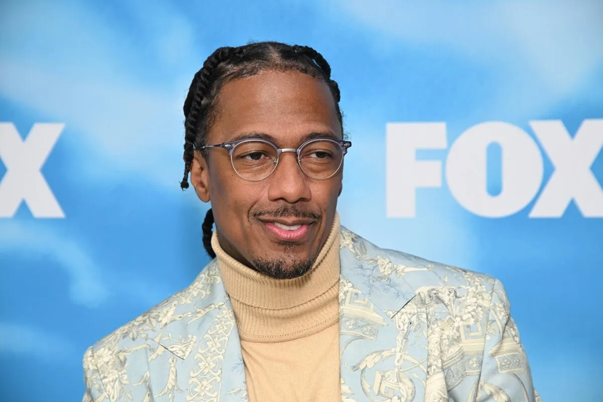 Nick Cannon posing ina tan turtle neck and green blazer at the FOX fall press day at Fox Studio lot.