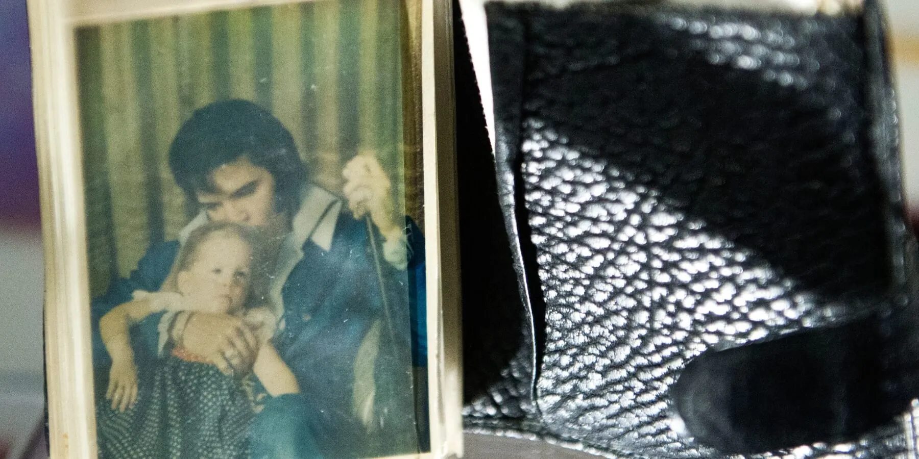 A photo of Lisa Marie Presley and Elvis Presley in his wallet, on display at Graceland.