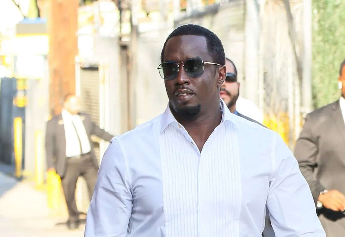 Sean 'Diddy' Combs wears a white button down shirt and sunglasses.