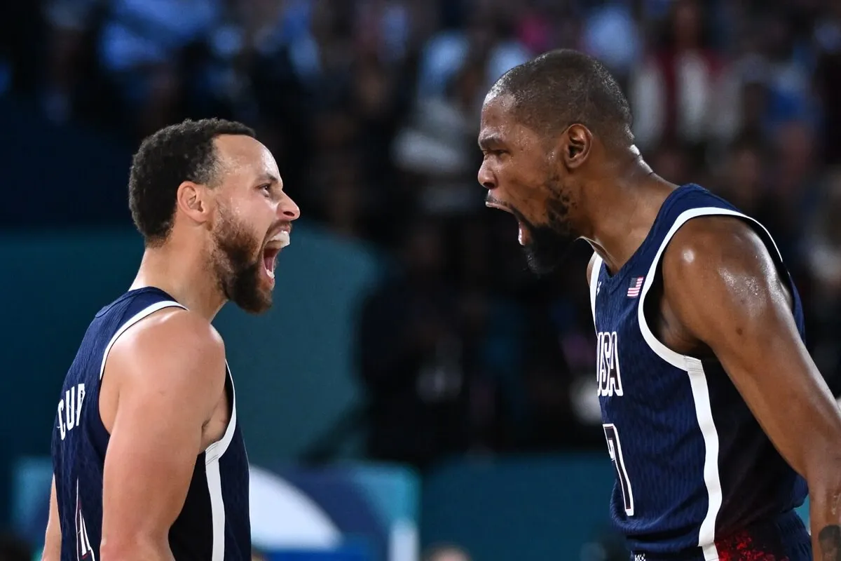 Stephen Curry and Kevin Durant celebrate after scoring in the Men's Gold Medal basketball match between France and USA during the Paris 2024 Olympic Games