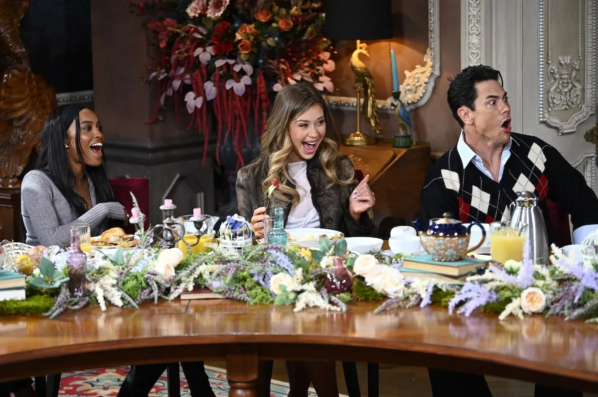 Season 3 stars Ciara Miller, Gabby Windey, and Tom Sandoval film 'The Traitors' at a table in their Scottish castle